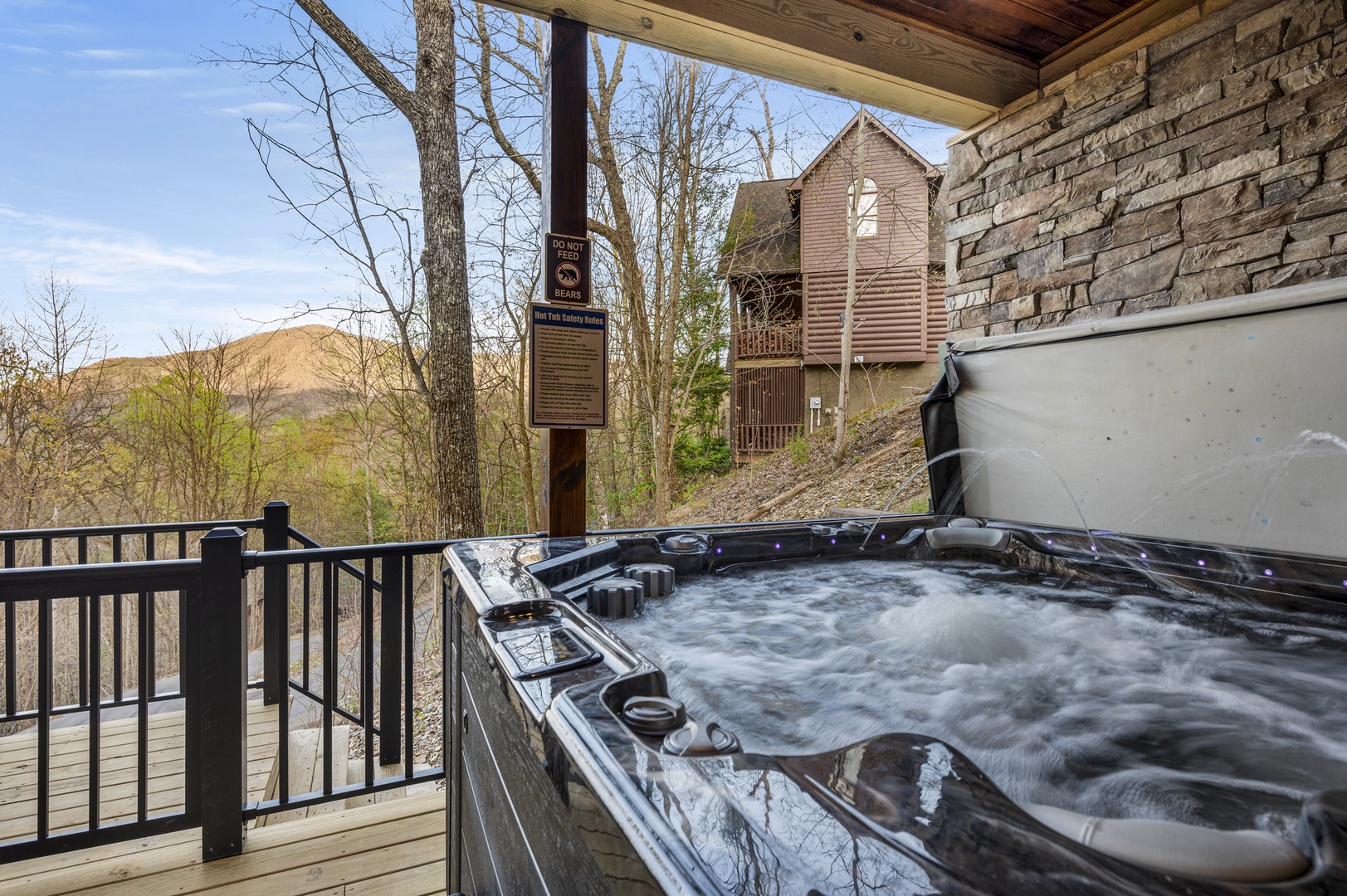 Spacious deck with outdoor seating and hot tub