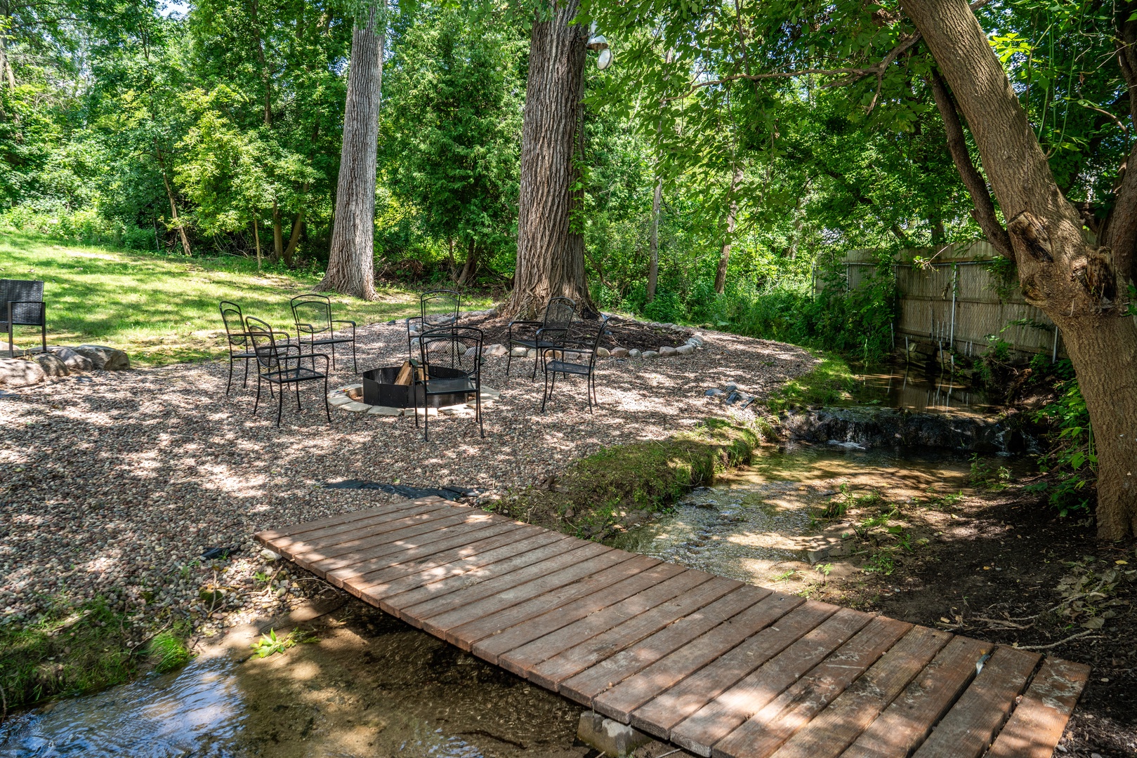 Unwind in the secluded backyard, serenaded by the soothing sounds of the stream