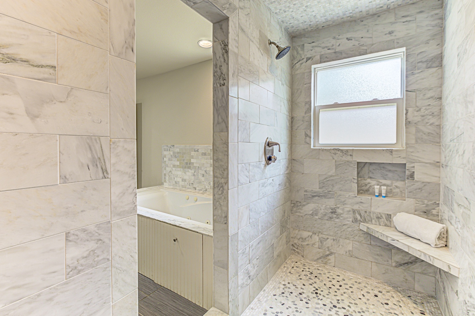 Enjoy a double vanity, Jacuzzi tub, & walk-in shower in the king ensuite