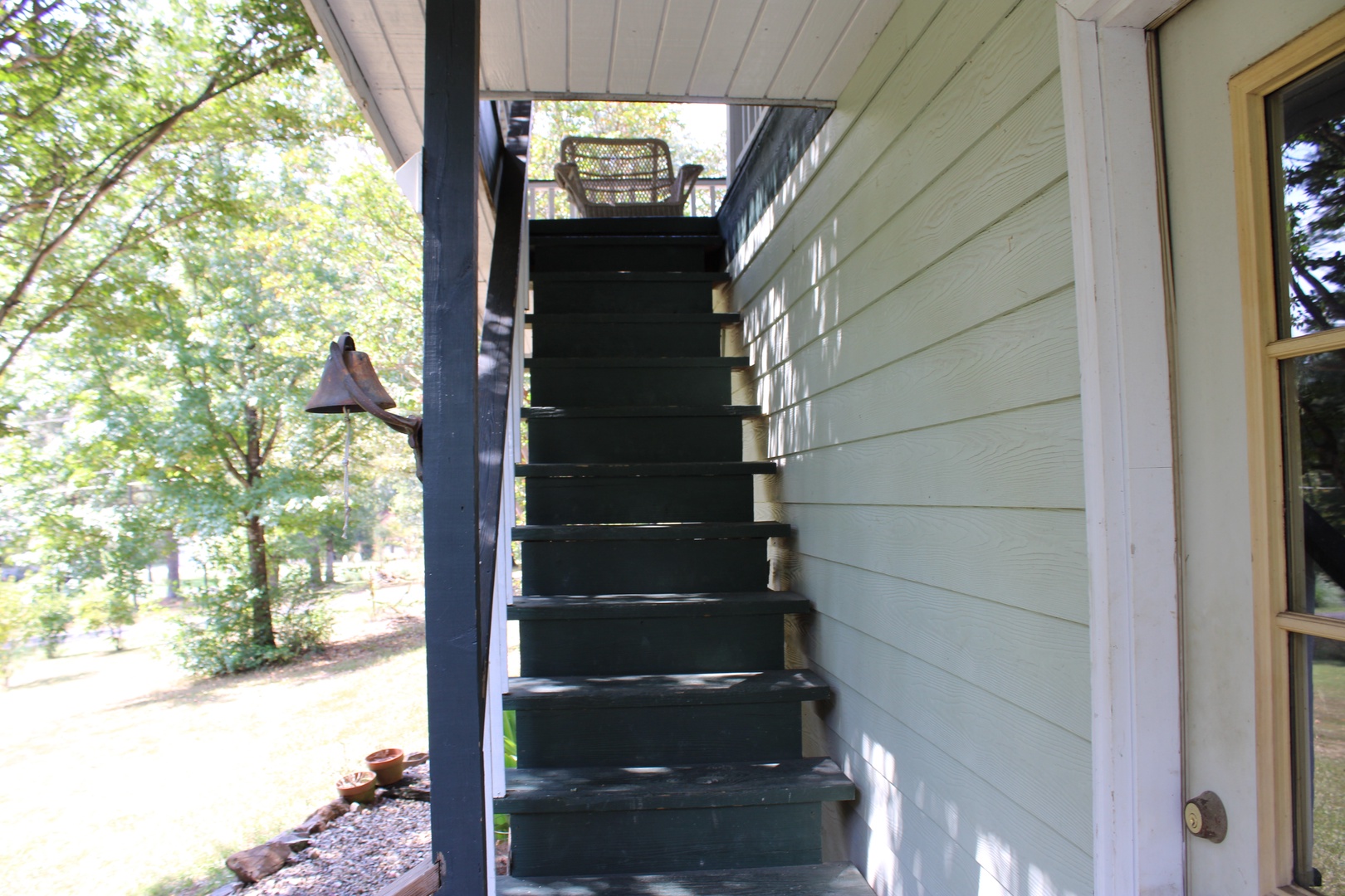 Head up the exterior staircase to the main entrance of this charming home