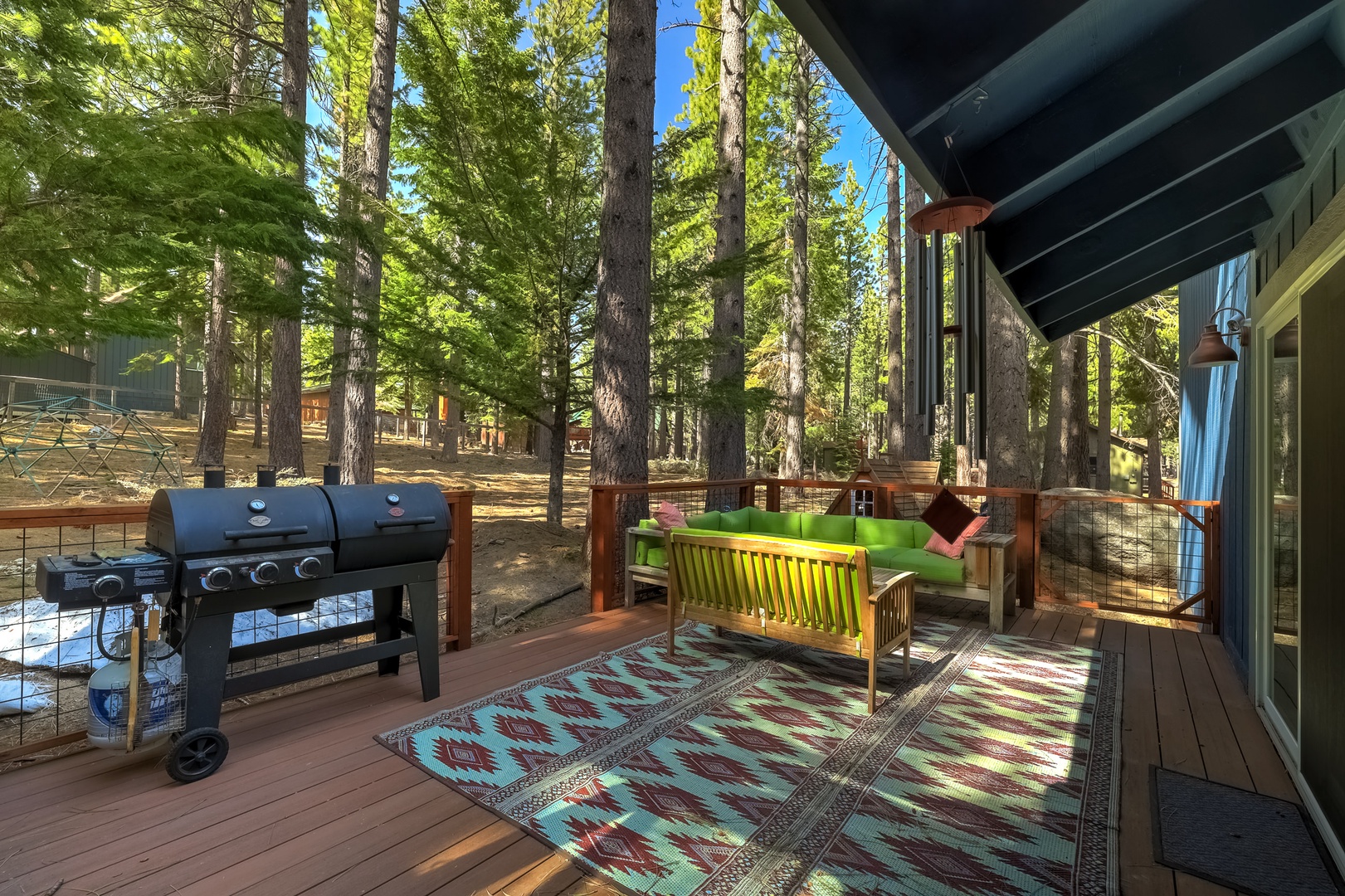 Deck with ample outdoor seating, and private hot tub