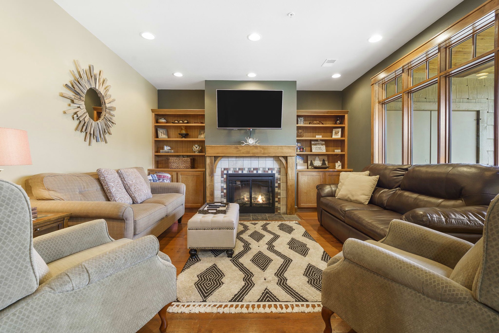 Open living space with sofa sleeper, TV, and fireplace