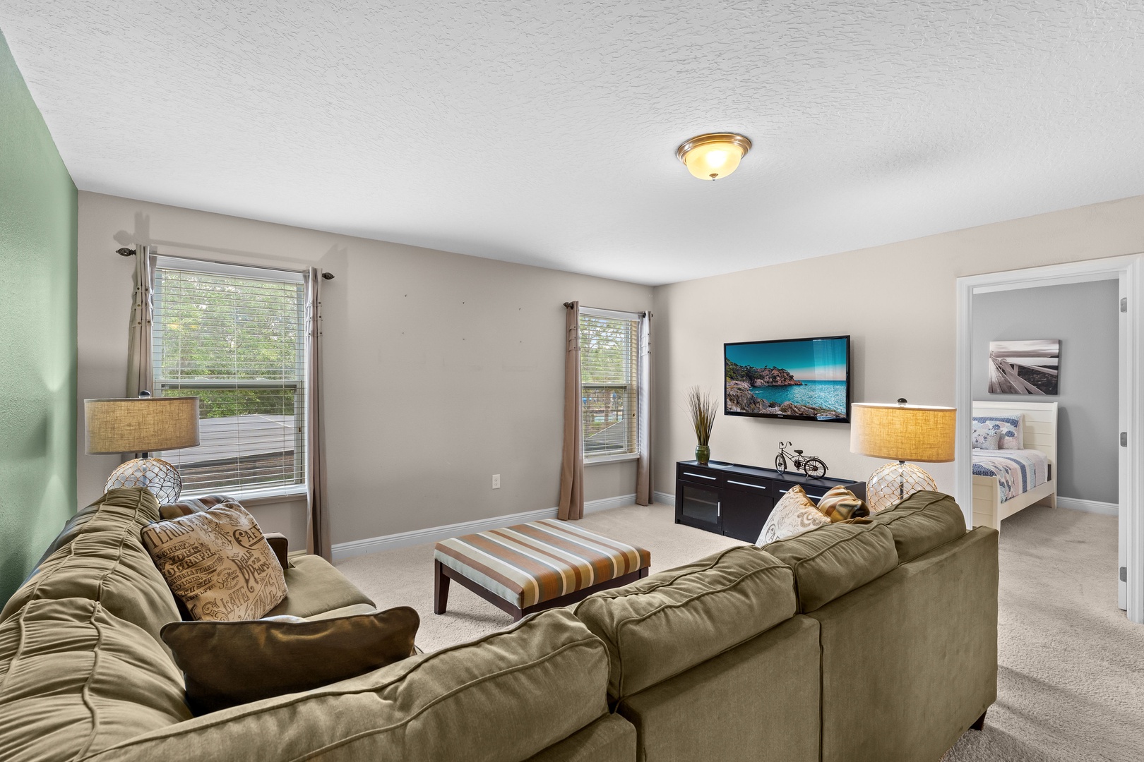 Second floor living area with sectional seating and Smart TV