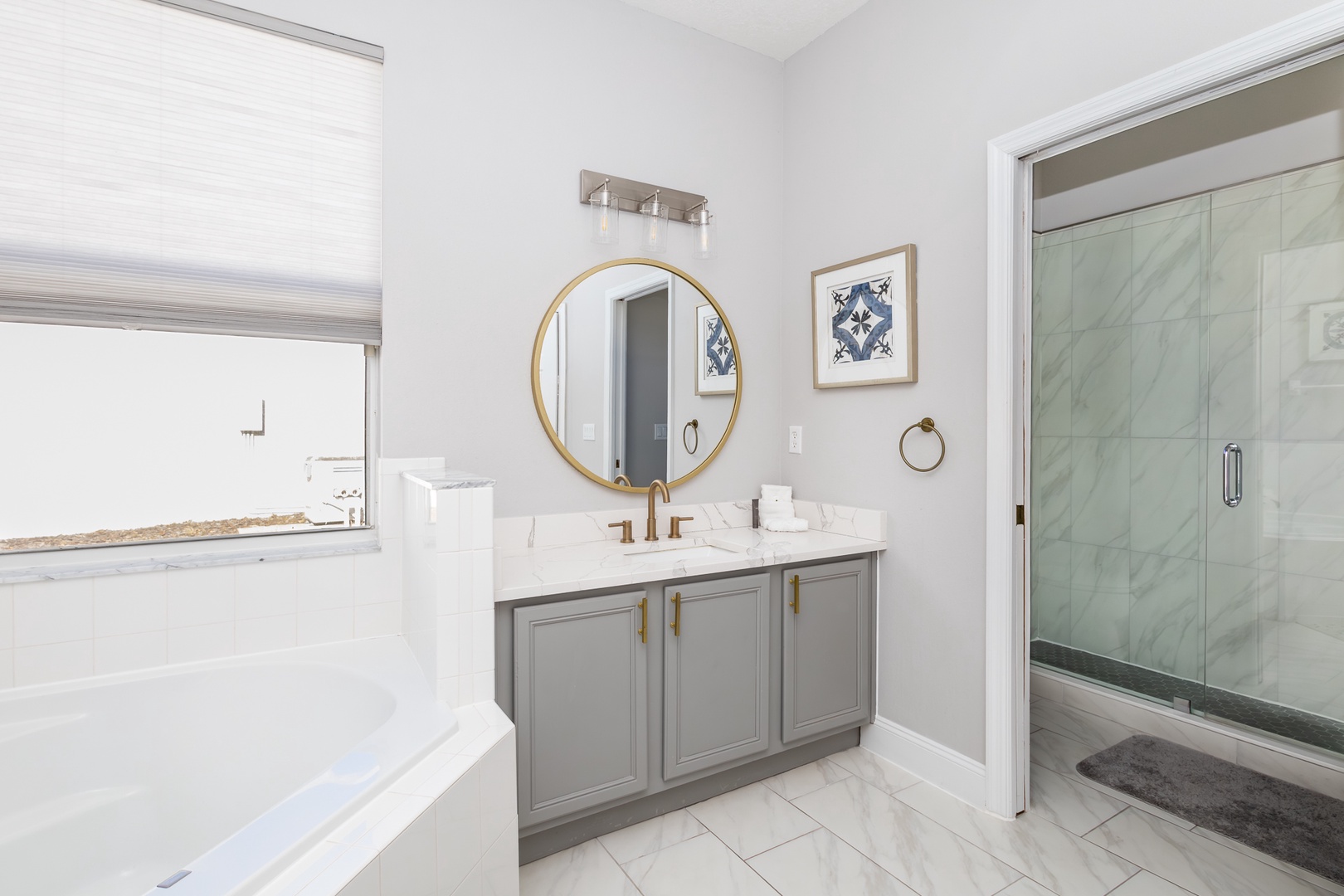 Indulge in this modern bathroom featuring a walk-in shower and a separate soaking tub