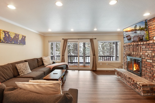 Living area with fireplace, deck, and Smart TV