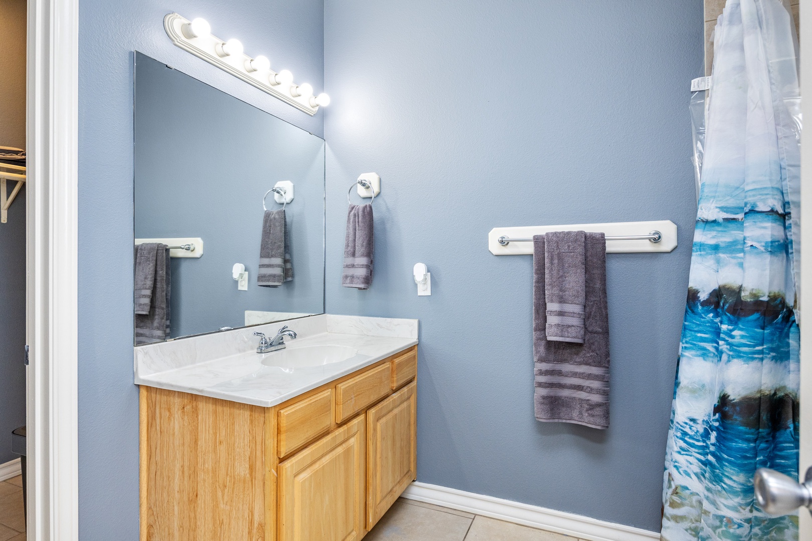 The downstairs bathroom includes a single vanity & walk-in shower