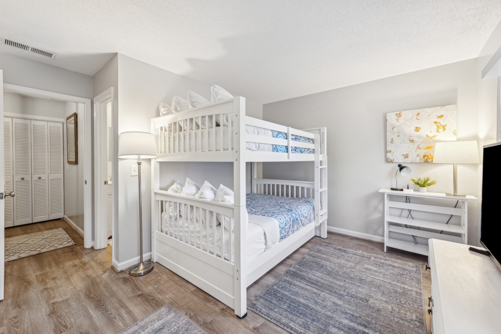 Relax in this cozy room featuring a full over full bunk bed, trundle & Smart TV