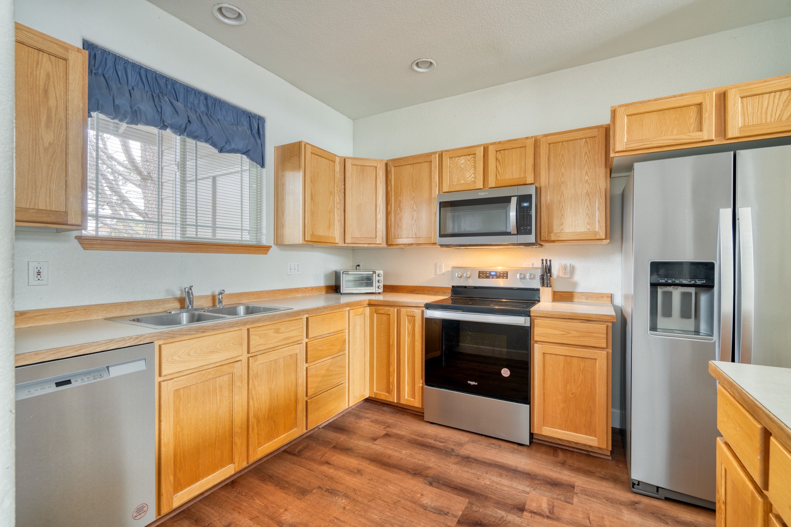 The open, airy kitchen offers ample space & all the comforts of home