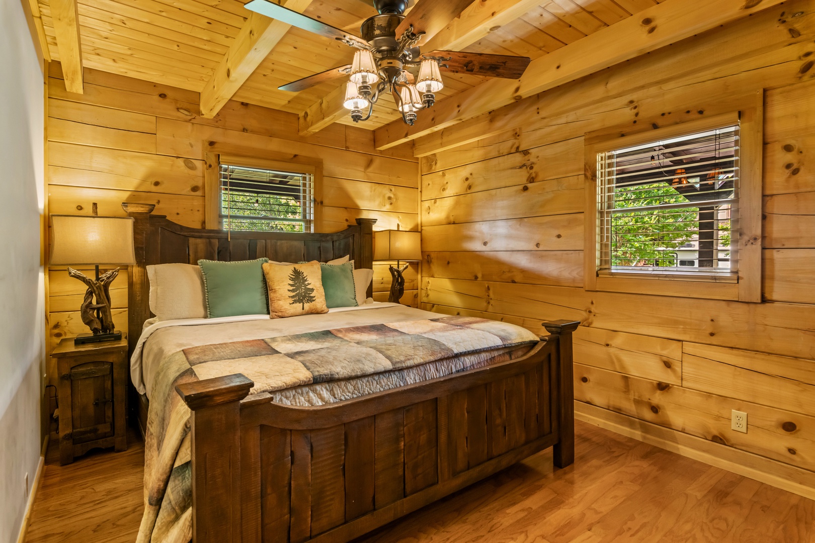 The first of two main-level bedrooms boasts a regal king-sized bed