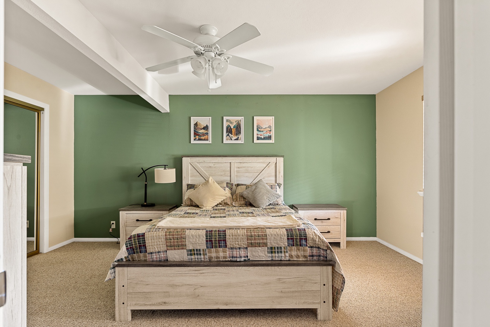 The first of two bedroom offers a queen bed, ceiling fan, & plenty of space