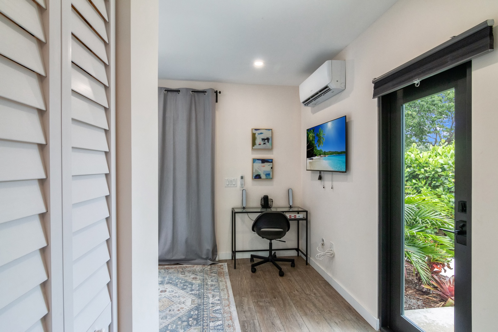 Bedroom with queen bed, work station, Smart Tv and patio access