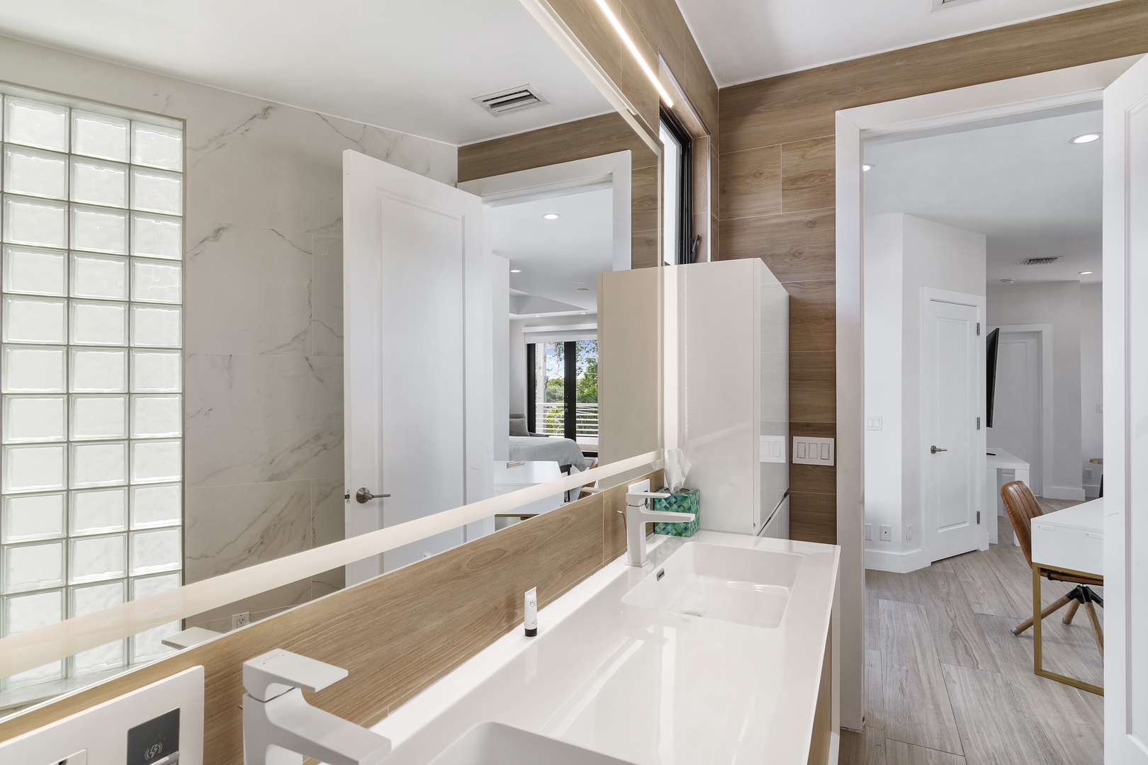 The king ensuite features a large vanity, glass shower, & luxurious soaking tub
