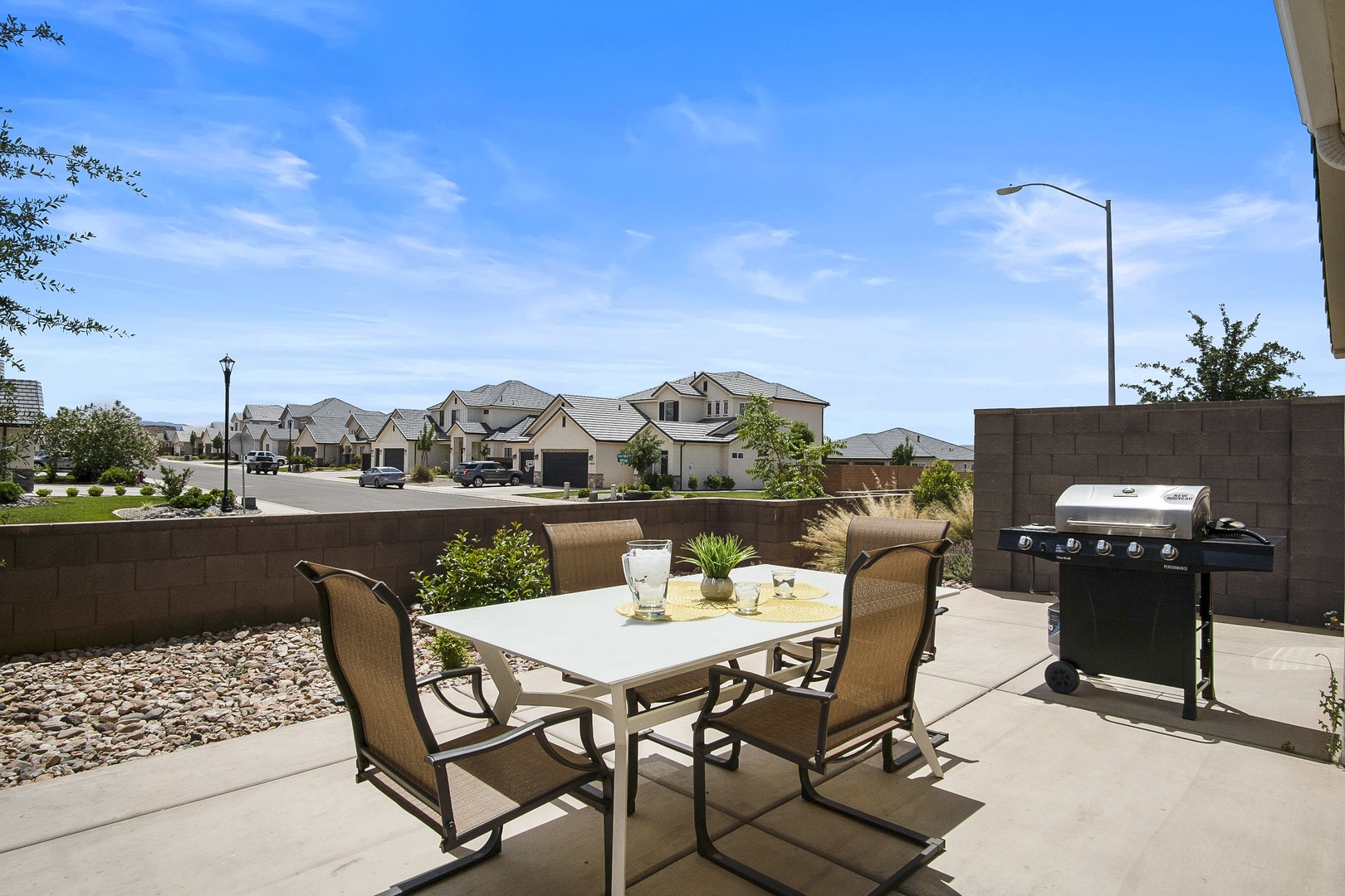 Outdoor dining with seating and BBQ grill