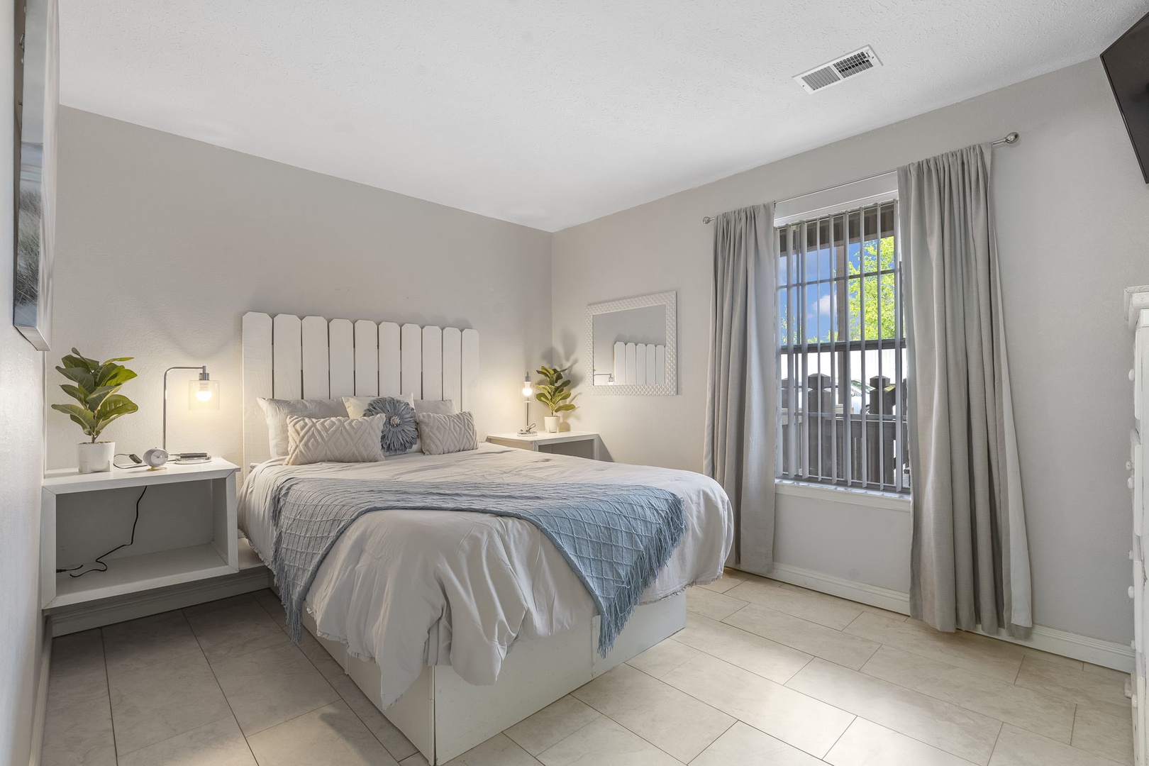 The tranquil Bedroom offers a queen-size bed and TV