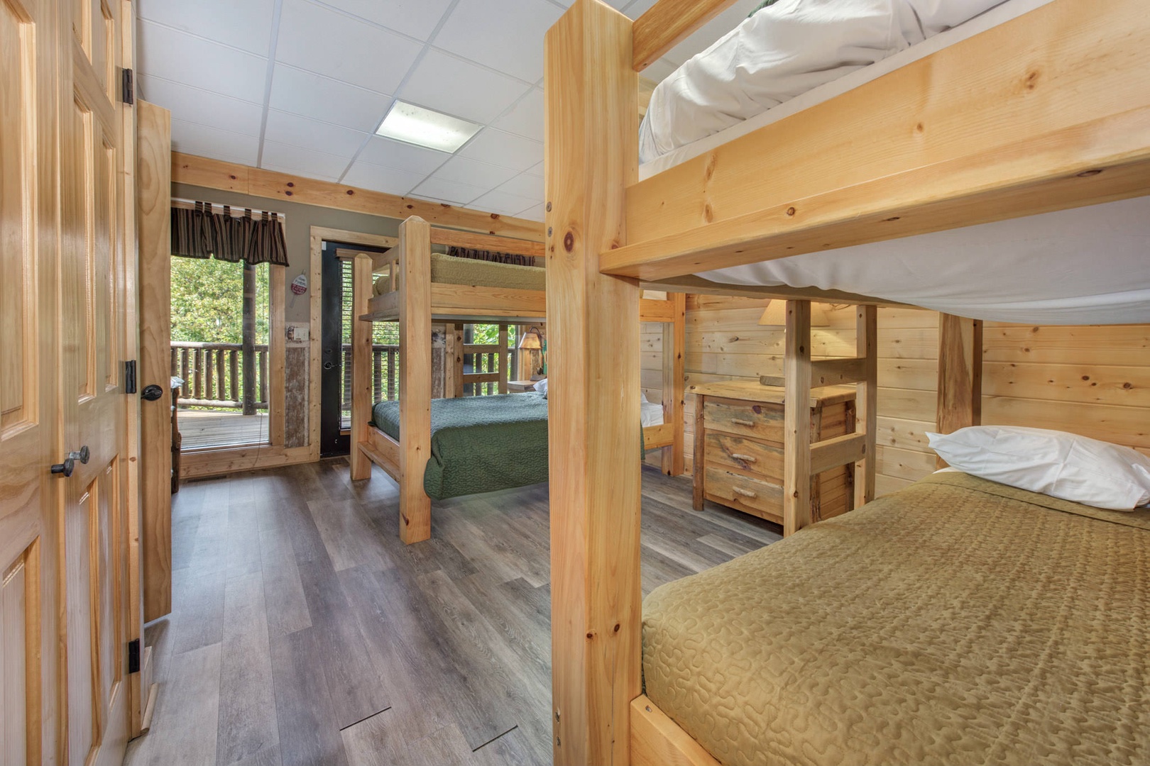 Bedroom 4 with 2 sets of Queen/Queen beds, Smart TV, deck access, and private en-suite