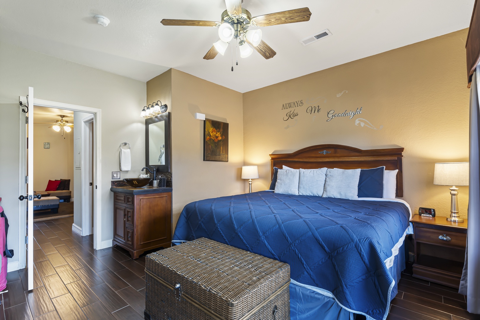The bedroom includes a regal king bed, Smart TV, & patio access