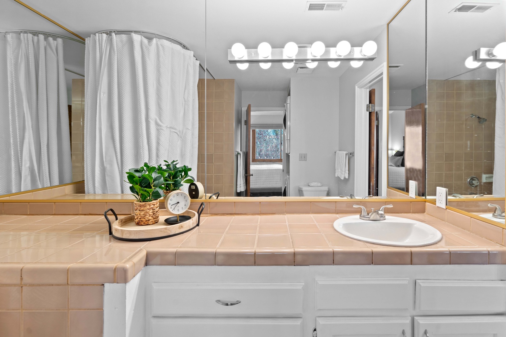 The full bath features a large vanity & shower/tub combo