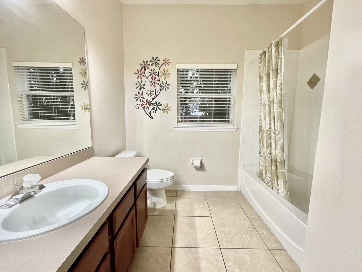 This full shared bath showcases a single vanity & shower/tub combo