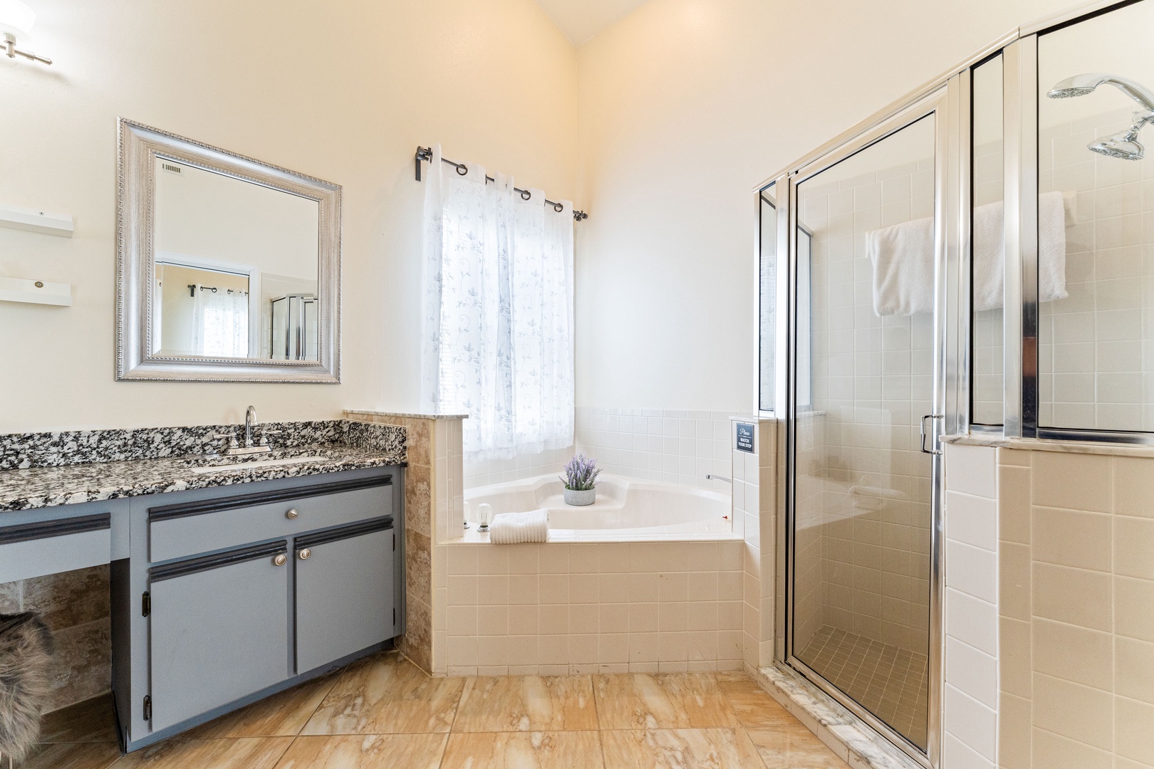 Enjoy a double vanity, shower, & soaking tub in this ensuite bath