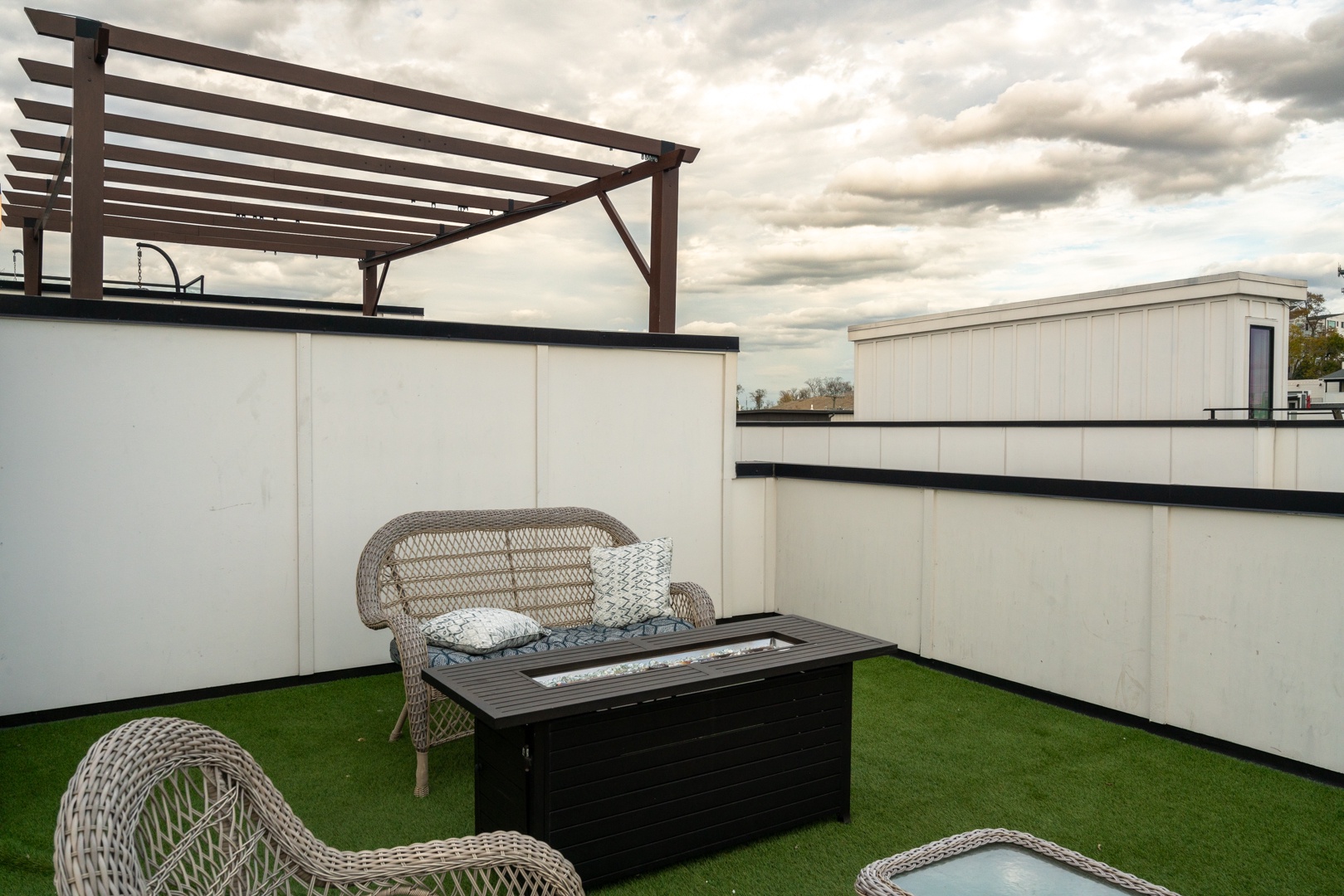Rooftop deck with outdoor seating, firepit, corn hole, and grill