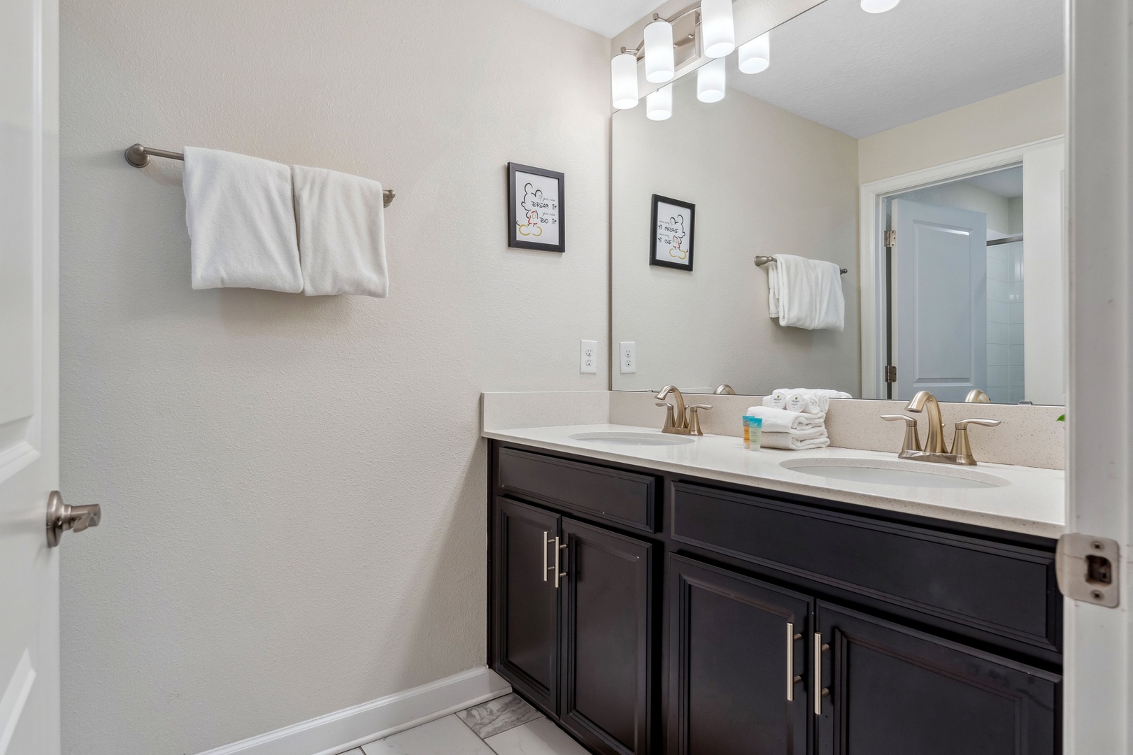 A double vanity, shower, & tub await in the ensuite bath