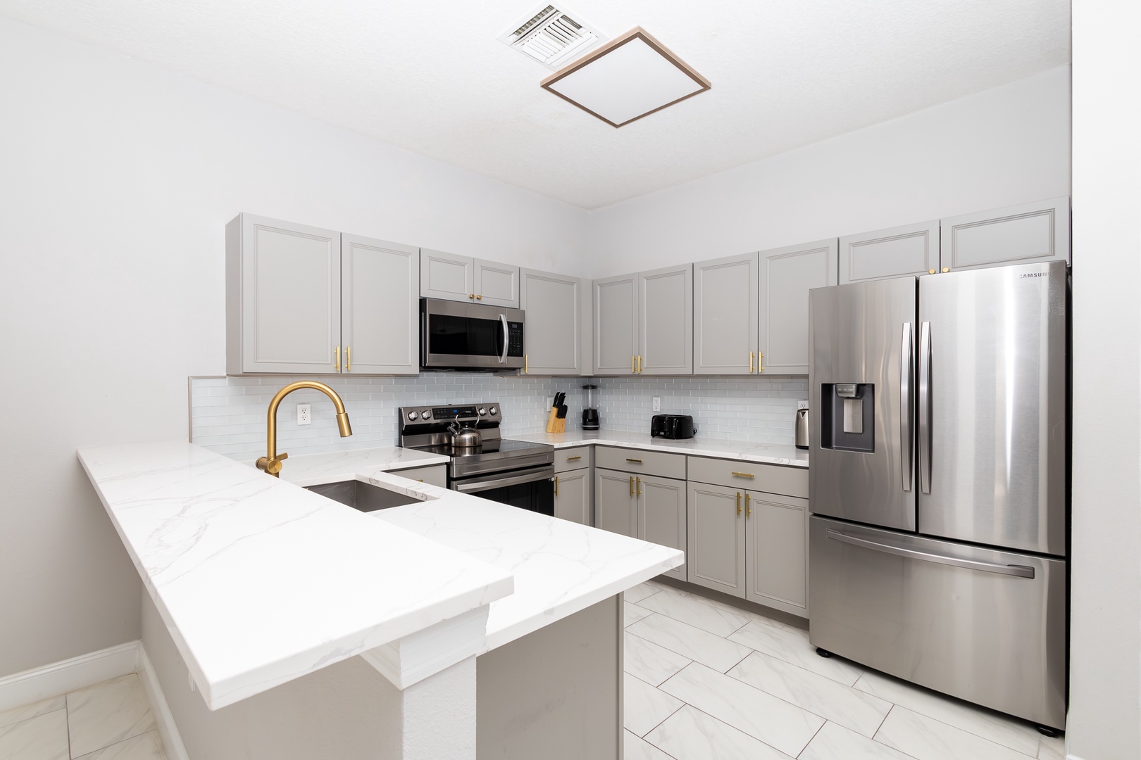 The open, airy kitchen offers ample space & all the comforts of home