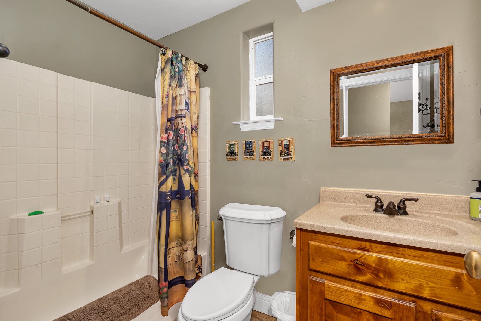 The 1st floor full bath offers a single vanity & shower/tub combo