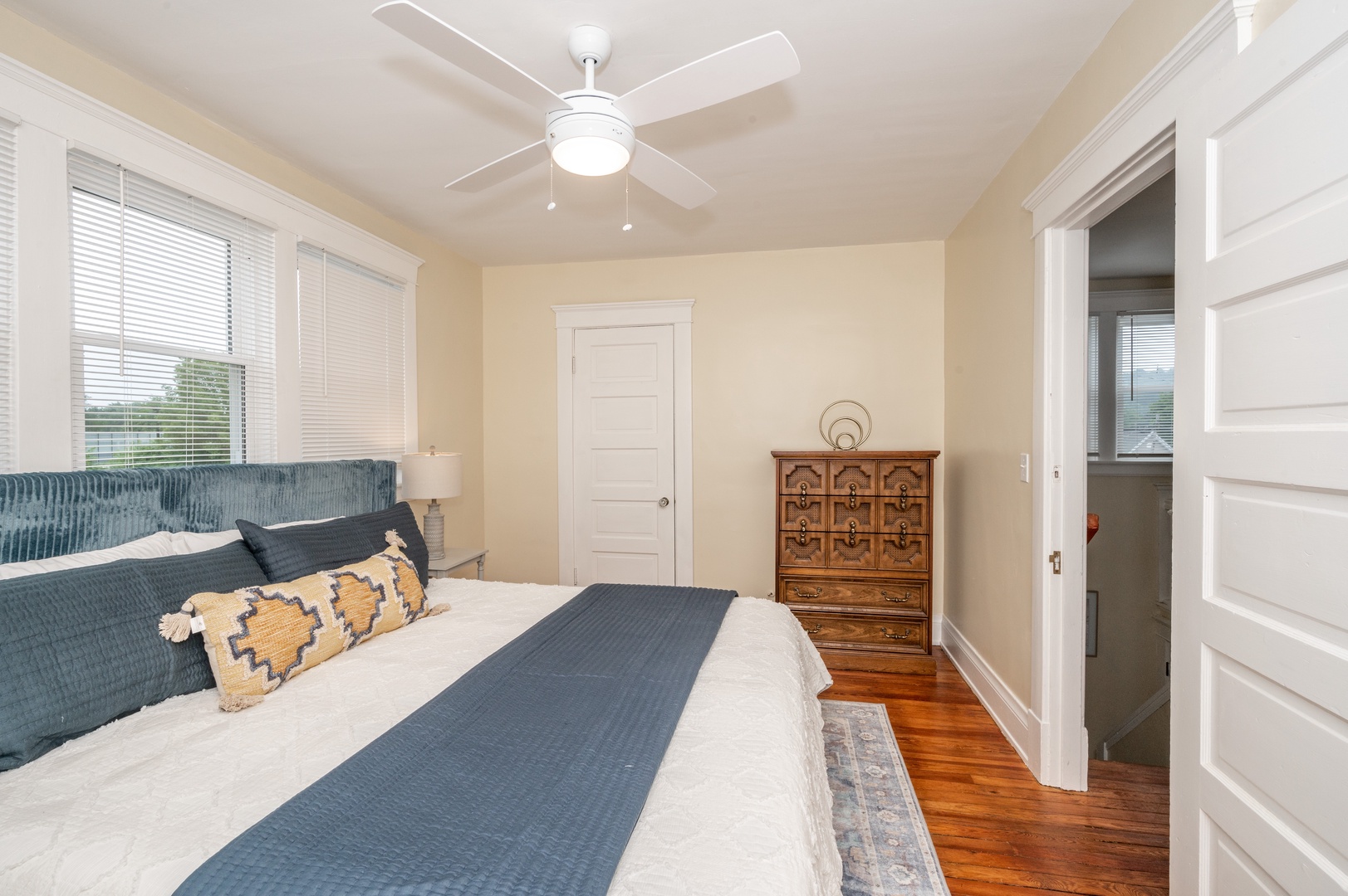 The 1st of 3 bedrooms offers a king bed & ceiling fan