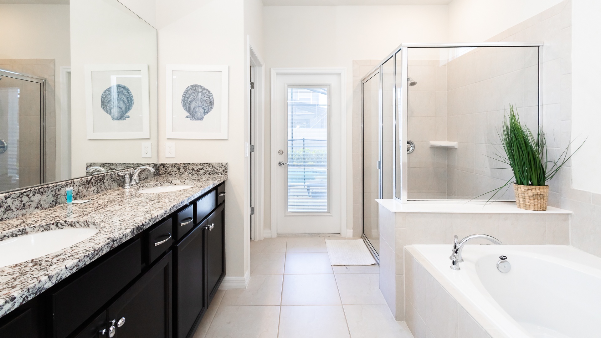 The 1st floor king en suite includes a dual vanity, glass shower, & soaking tub