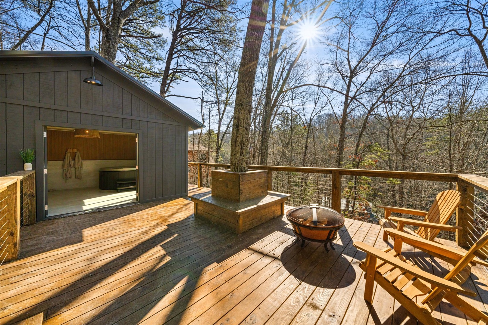 Lounge by the firepit in the sunshine on the oversized, treehouse-like deck