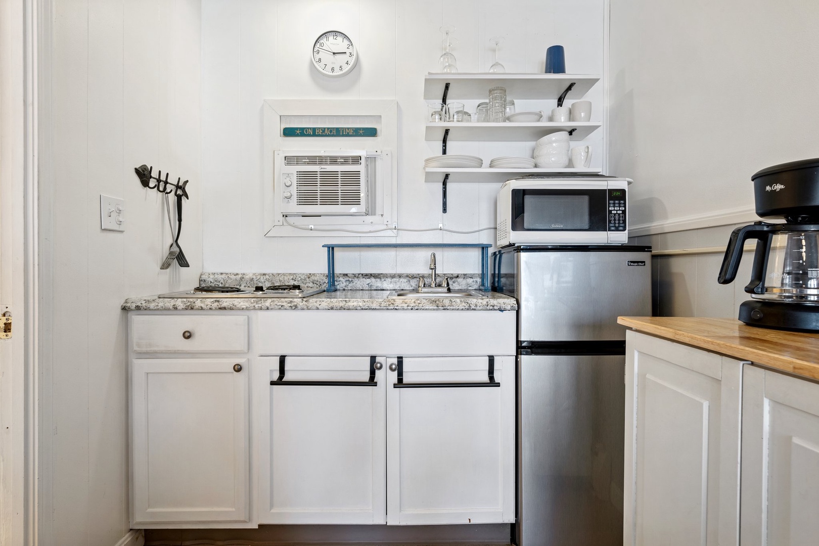 The cozy kitchenette offers ample storage & homey amenities