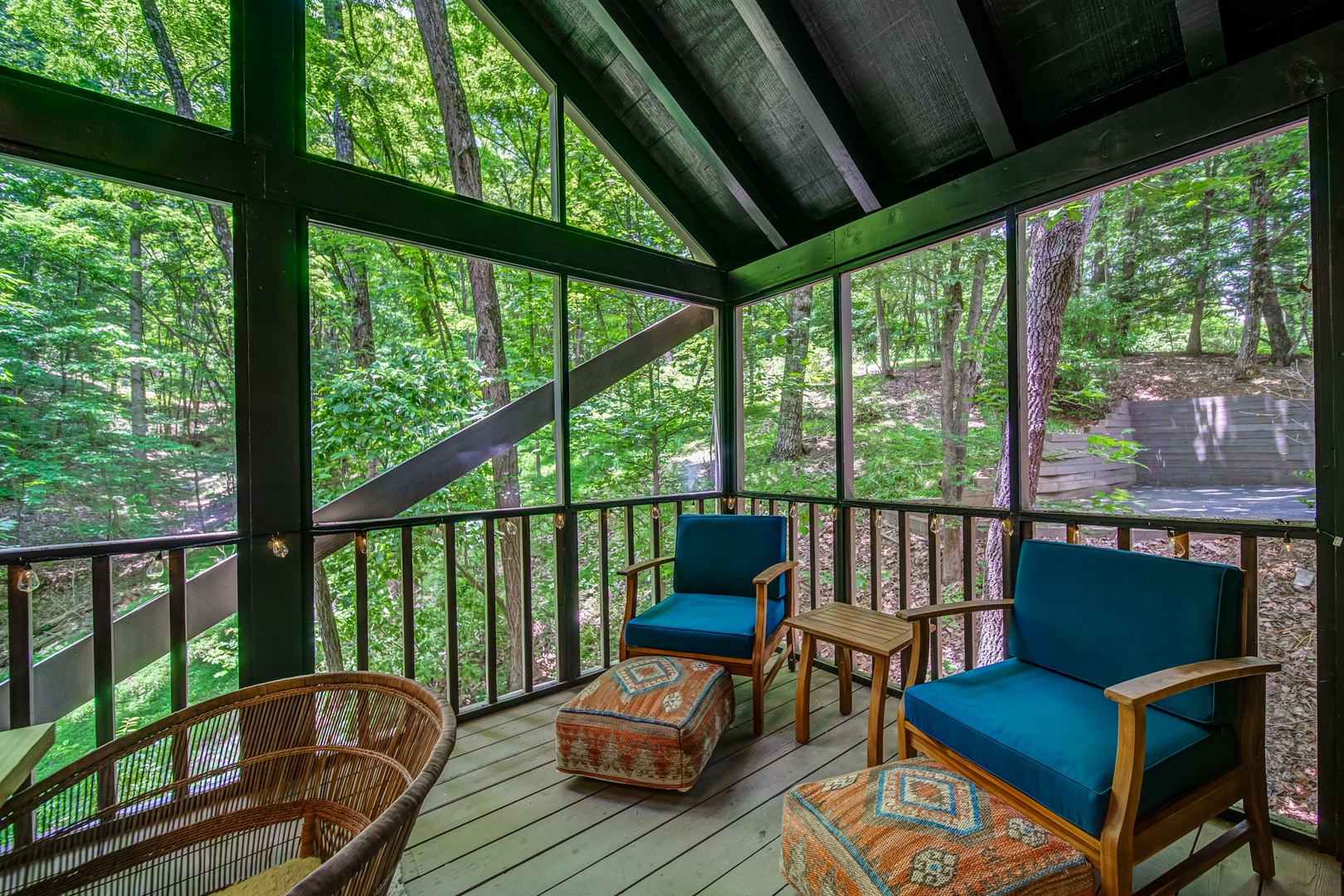 The main level screened-in porch offers tranquil space for relaxation in nature