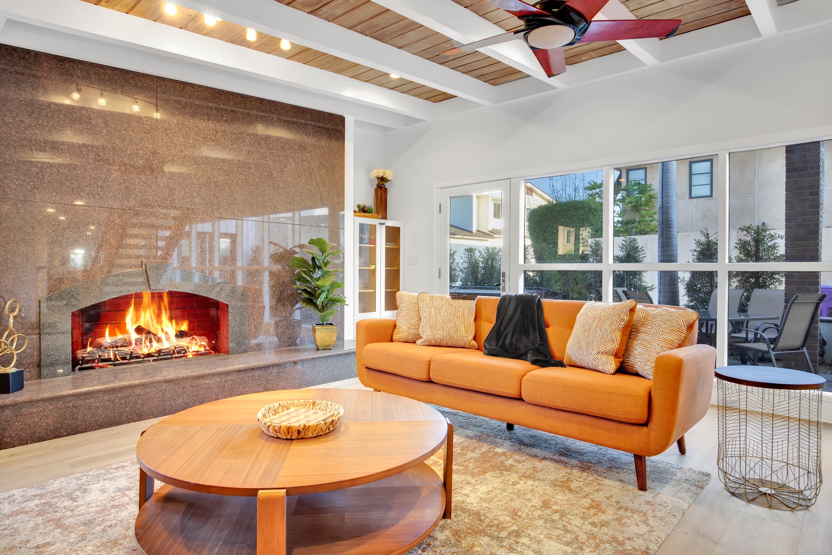Bright open lower living space with lush seating and fireplace