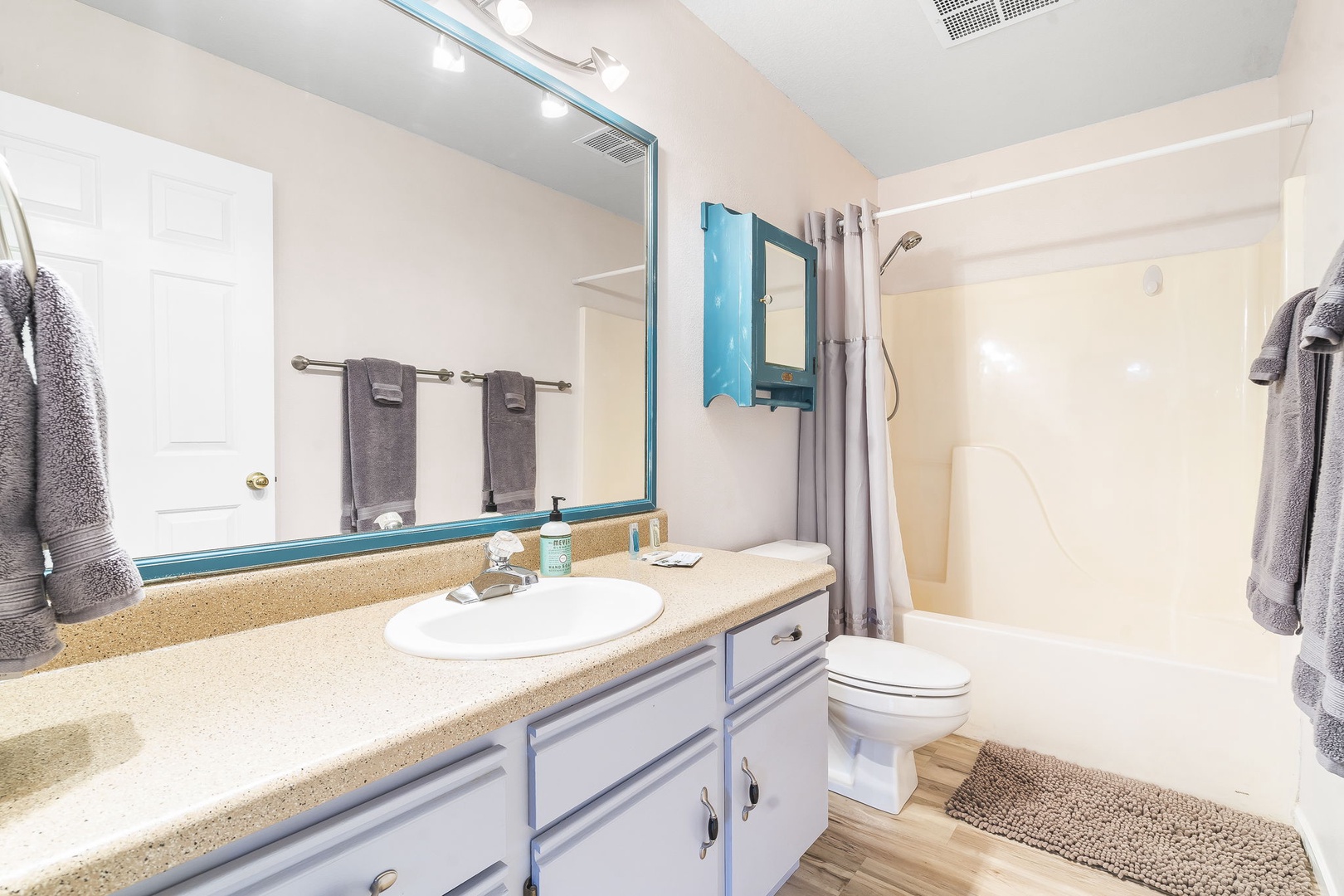 The 1st of 2 full bathrooms includes a large single vanity & shower/tub combo