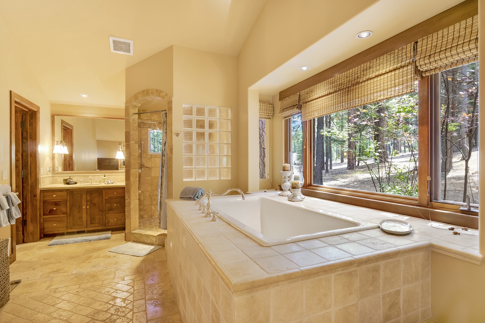 Ensuite bathroom with vanity, stand-up shower, and soaking tub