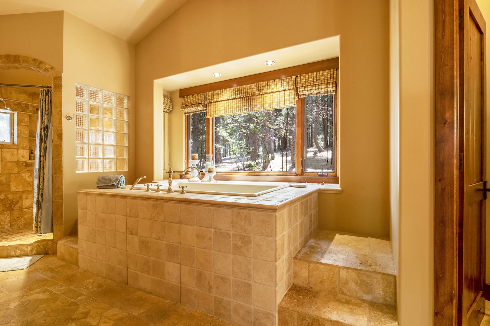 Ensuite bathroom with vanity, stand-up shower, and soaking tub