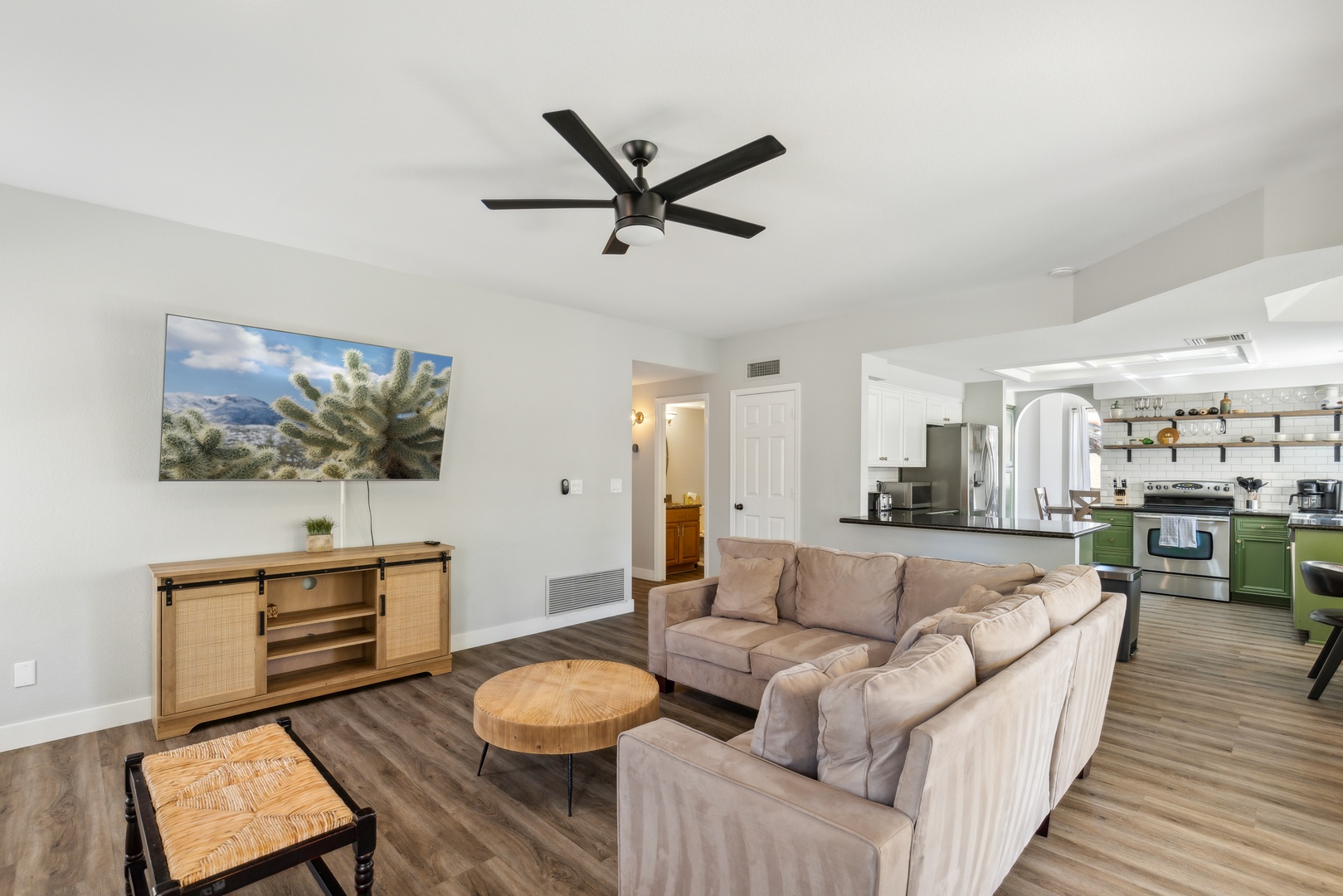 Living space off of the back yard with sectional sofa, fireplace, and Smart TV