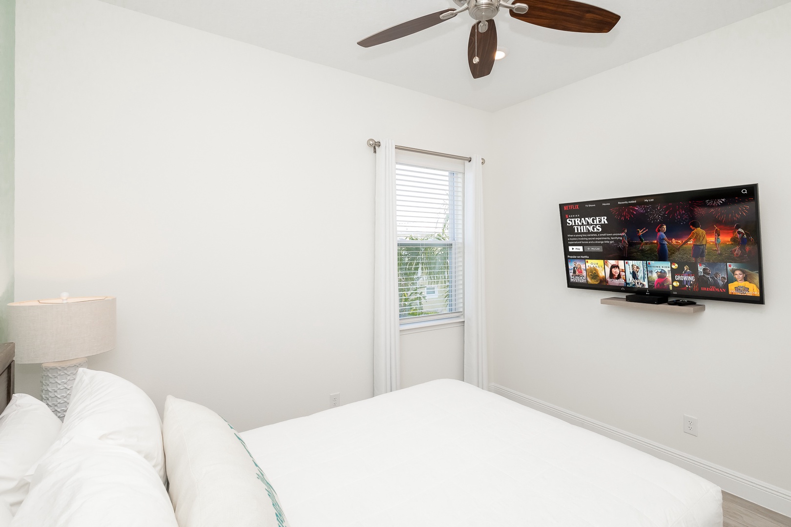 The beachy 2nd floor queen bedroom includes & Smart TV & organized closet