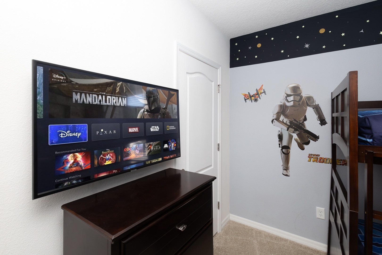 Star Wars-themed bedroom with double twin bunk beds and a smart TV