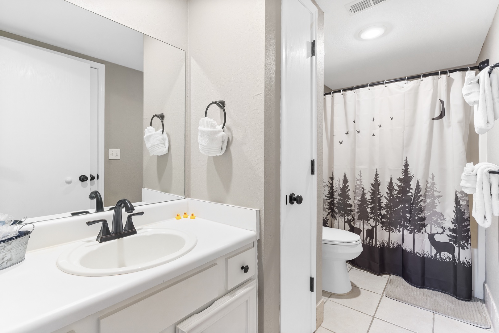 This ensuite links to the living area, featuring a single vanity & shower/tub combo