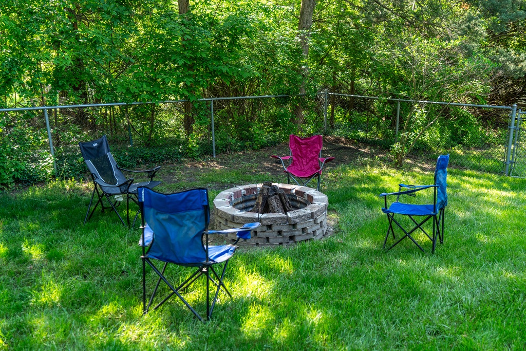 Enjoy the fire pit in the fenced in backyard.