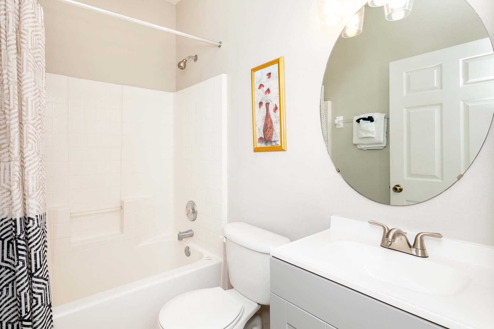 This full bath showcases a single vanity & shower/tub combo