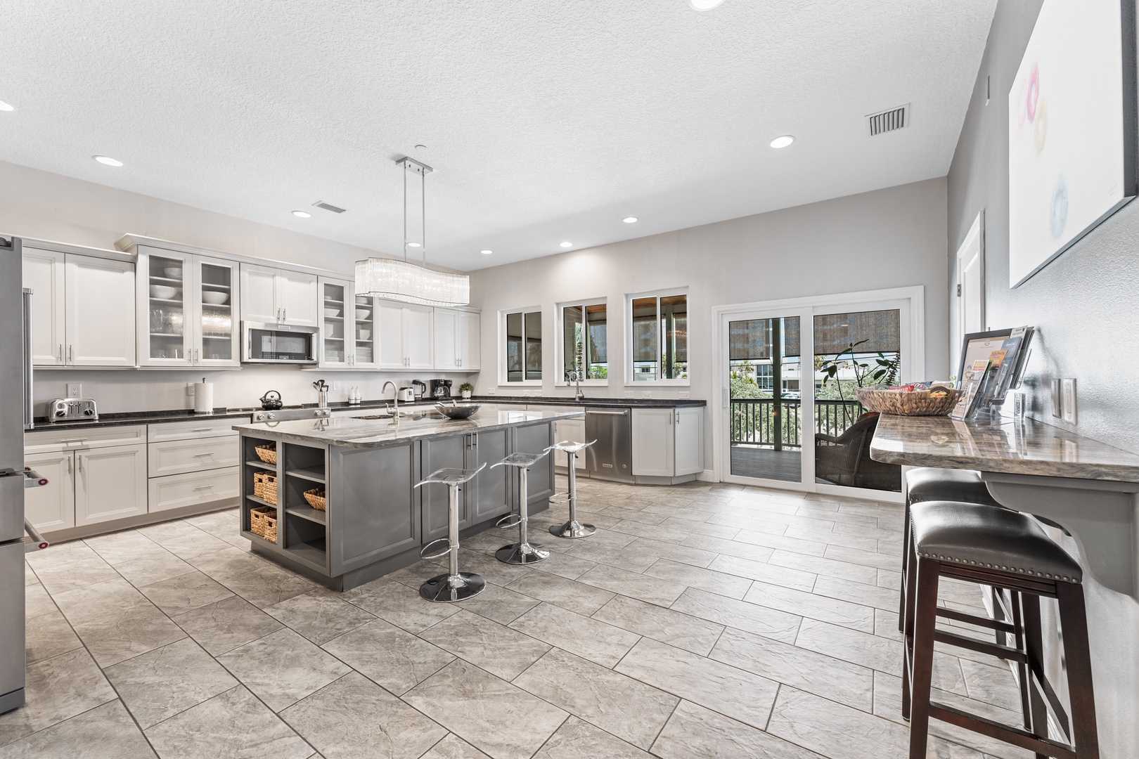 Fully equipped kitchen with counter seating and covered deck