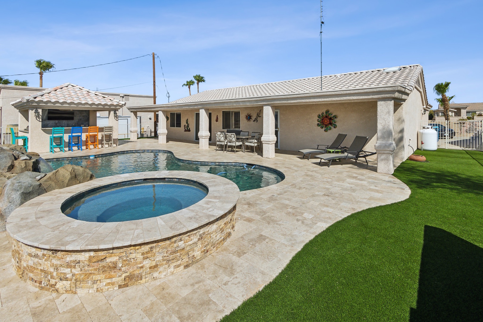 A mountain-view oasis, with a waterfall pool, hot tub, & outdoor kitchen!