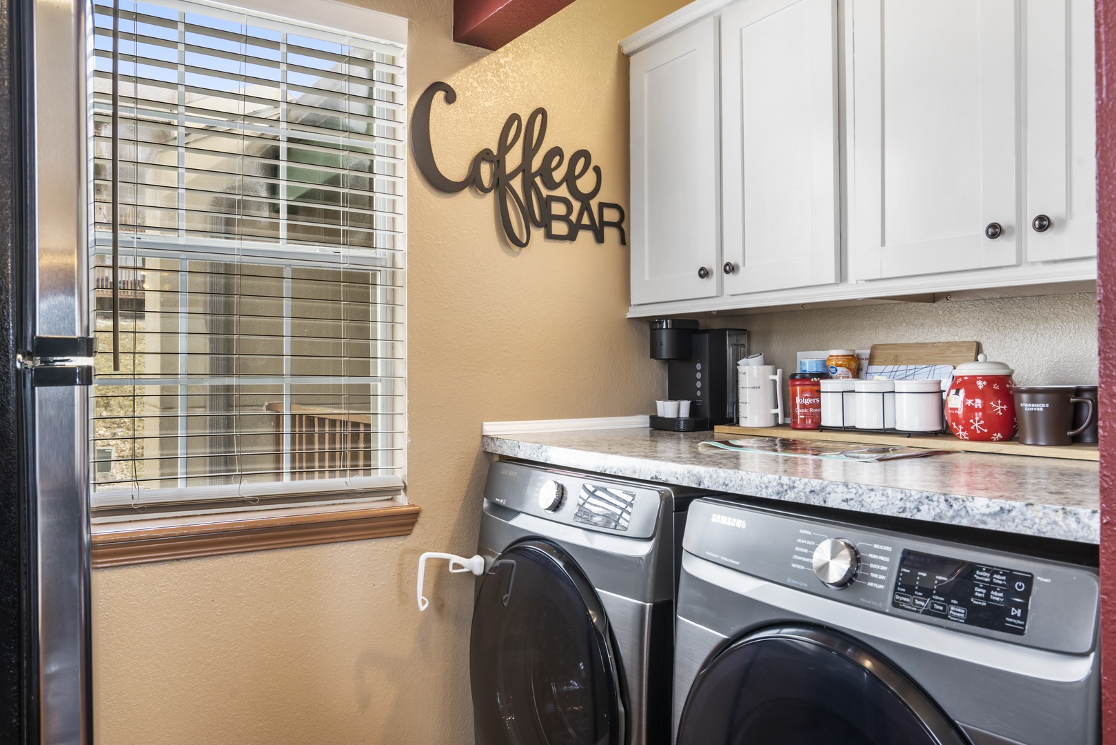 Private laundry is available for your stay, tucked away in the kitchen