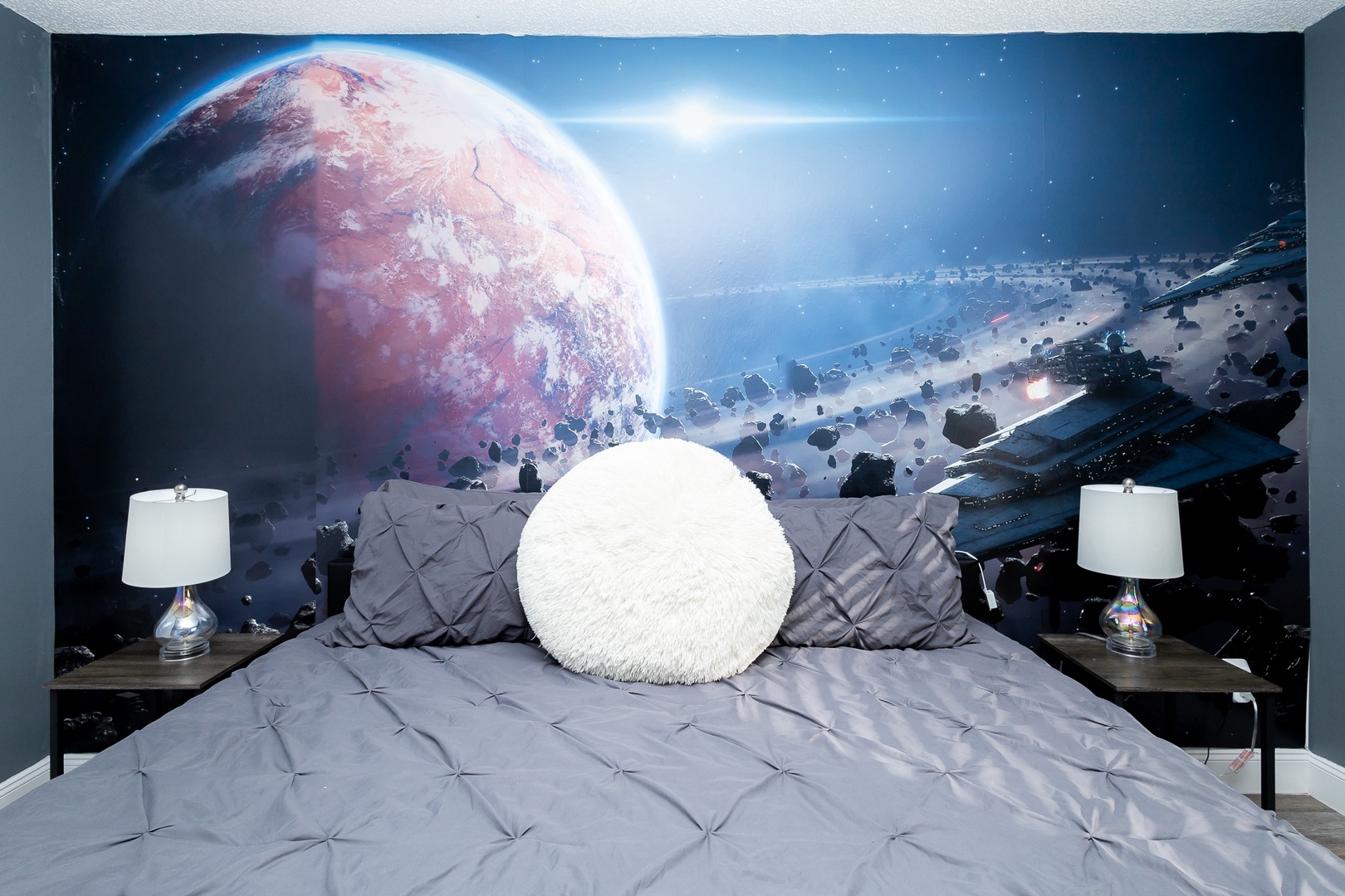 This queen bedroom with a Smart TV will take you to a galaxy far, far away