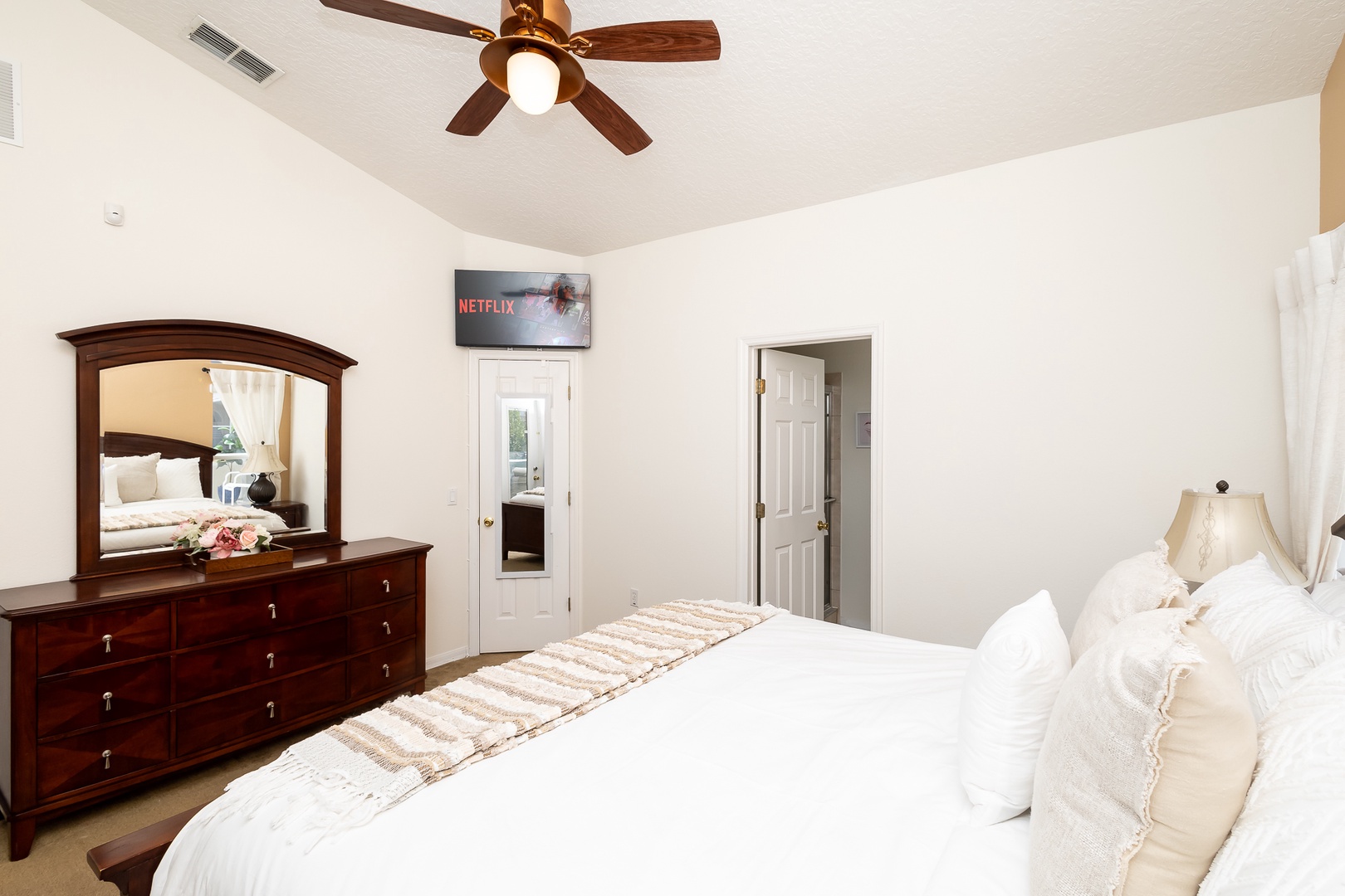 Bedroom 1 with king bed, Smart TV, patio access, and ensuite