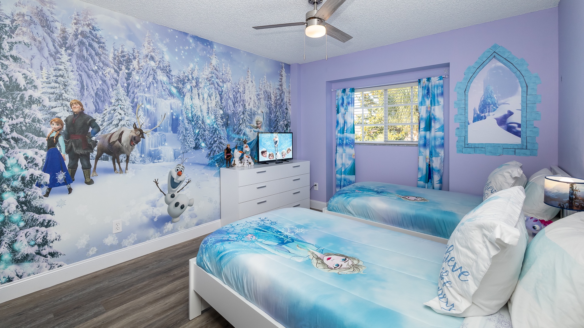 Let it go in this 2nd-floor bedroom, with a pair of twin beds & Smart TV