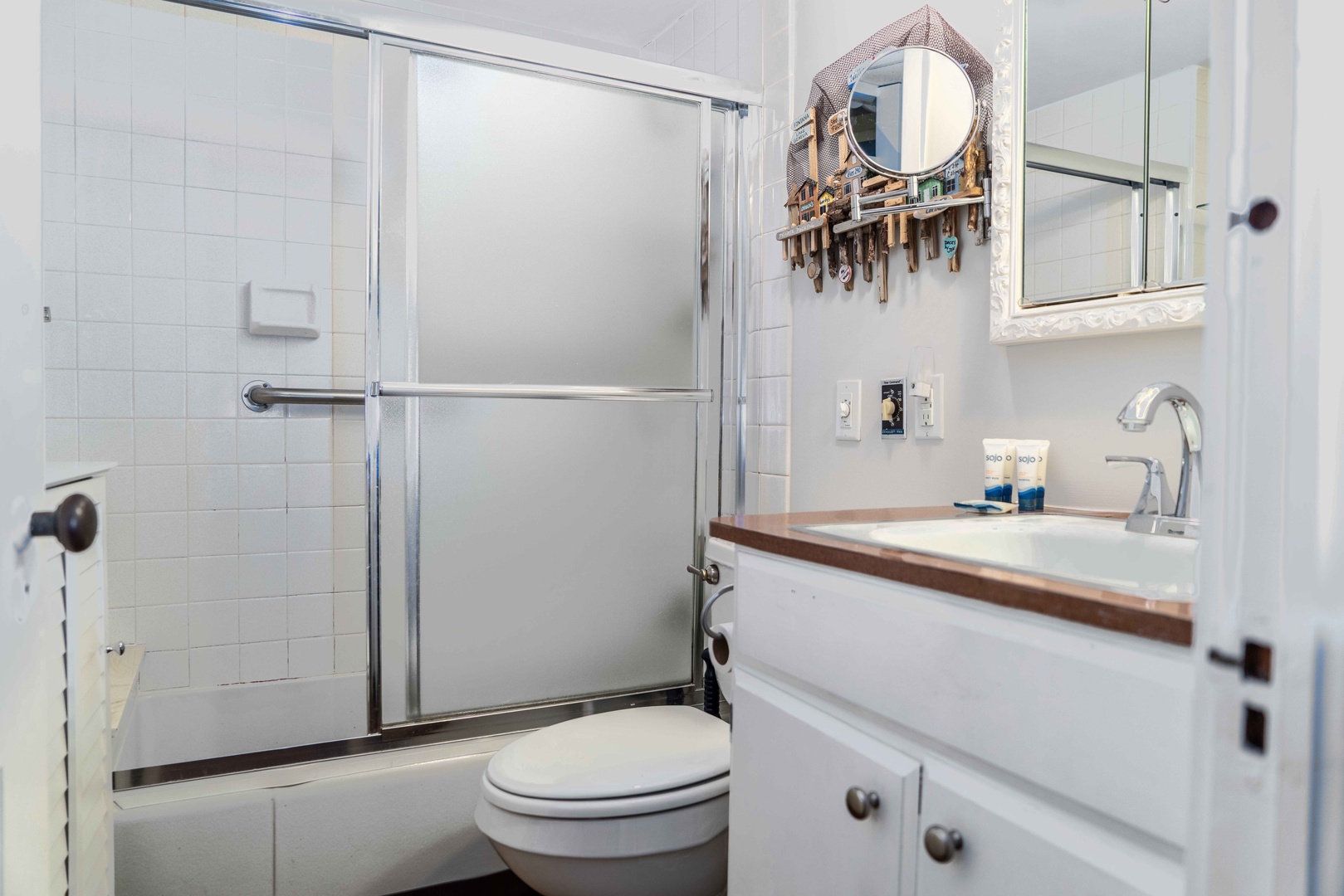 The full bathroom offers a single vanity & shower/tub combo