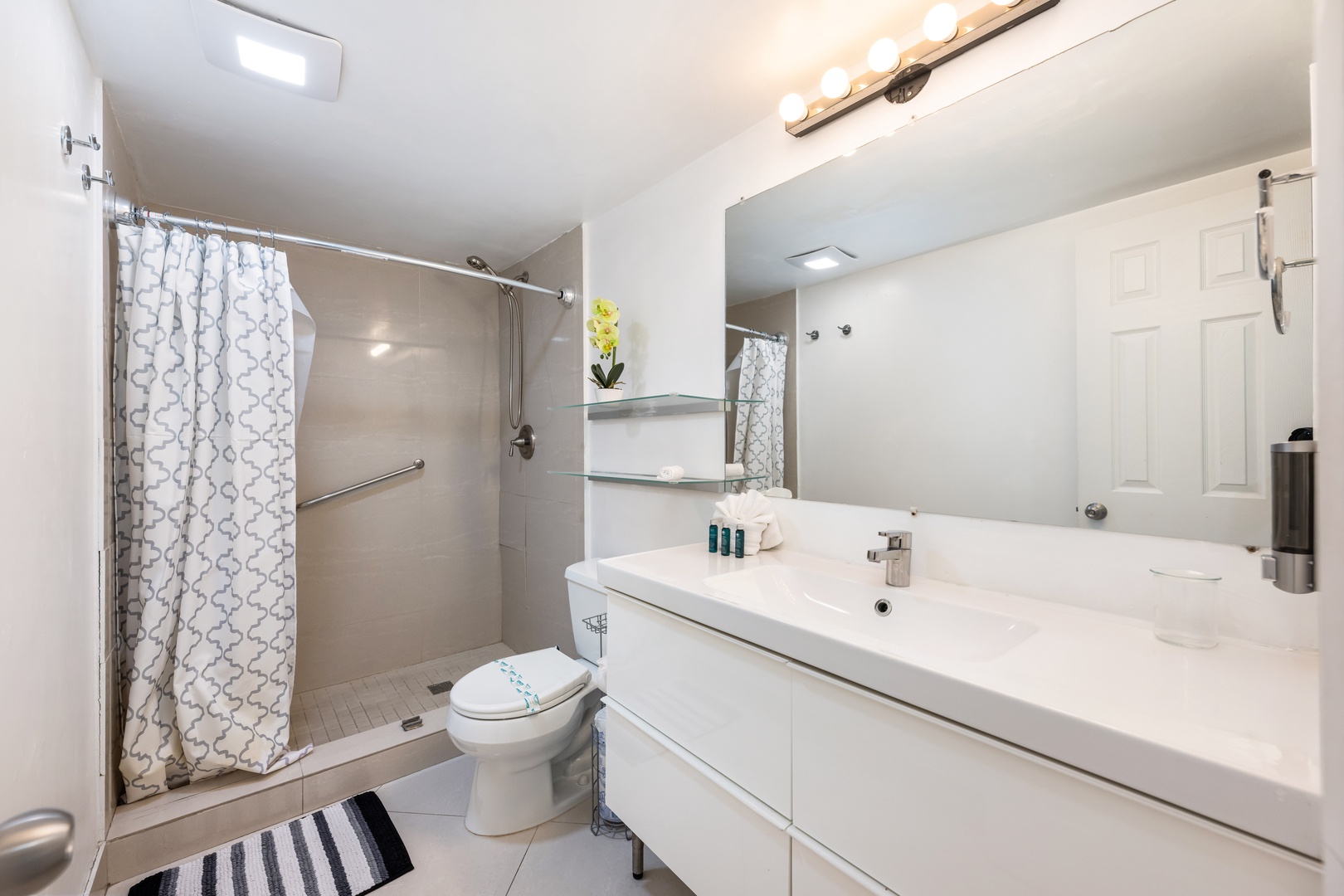The second full bathroom features a large single vanity & walk-in shower
